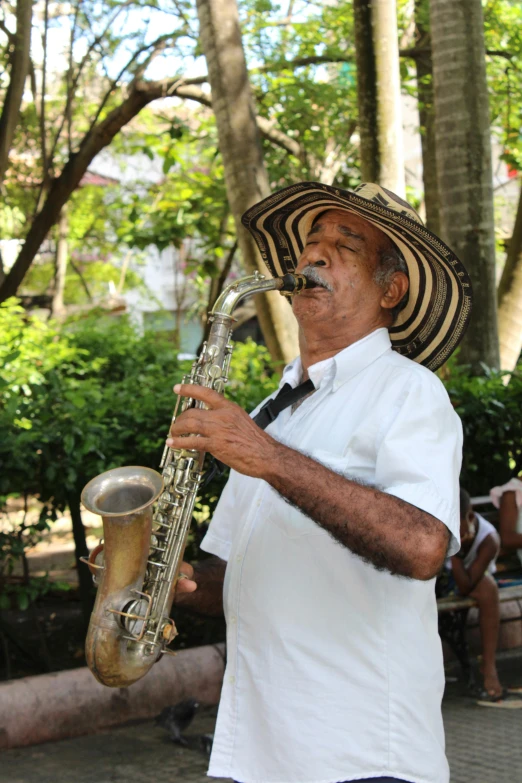 a man with a hat playing a saxophone