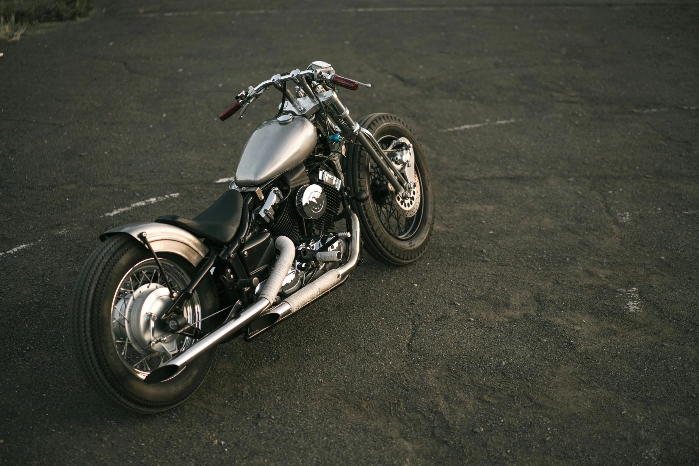 a motorcycle is parked in a parking lot, unsplash, photorealism, [ metal ], grey, single body, game ready