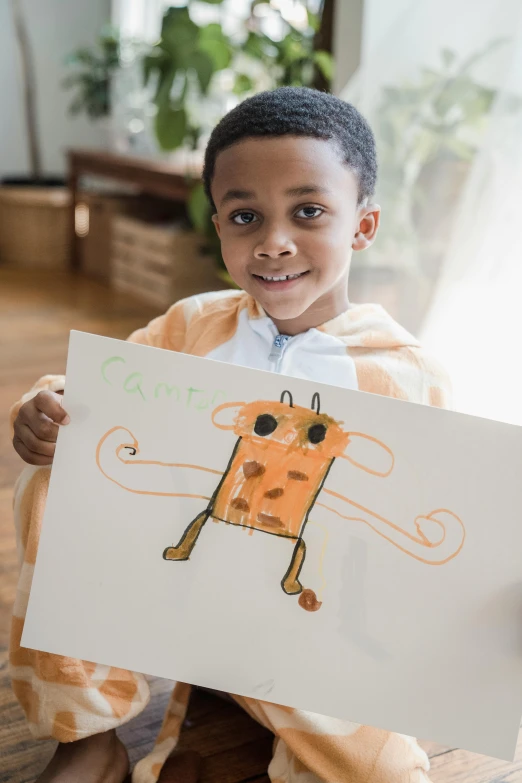 a young boy sitting on the floor holding a drawing, a child's drawing, inspired by Bill Traylor, pexels contest winner, portrait of kobe bryant, on a canva, walking towards the camera, closeup portrait