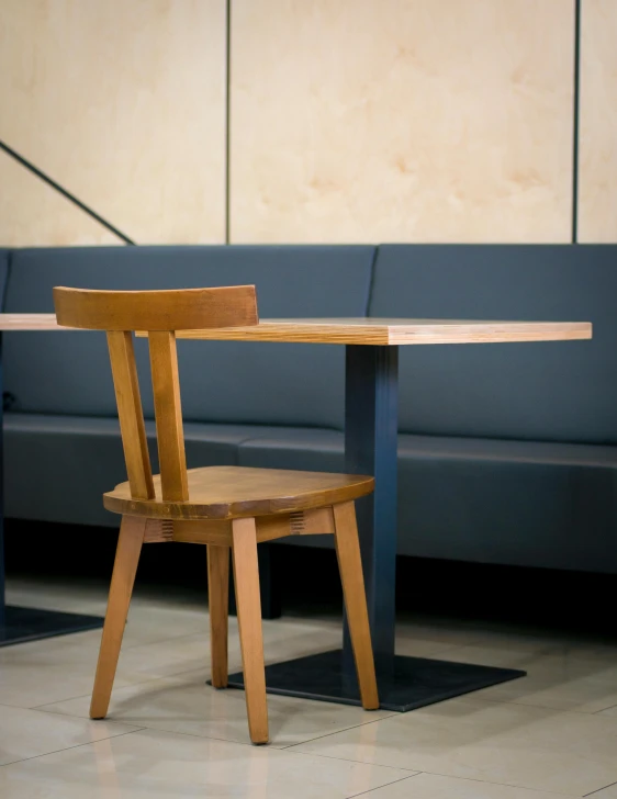 a wooden chair sitting next to a wooden table, inspired by Constantin Hansen, unsplash, modernism, food court, square, high-quality photo, thumbnail