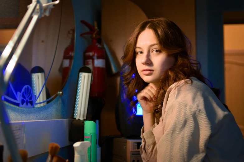 a woman sitting at a desk in front of a computer, a portrait, by Julia Pishtar, pexels contest winner, photorealism, russian lab experiment, mackenzie foy, in an underground laboratory, bisexual lighting