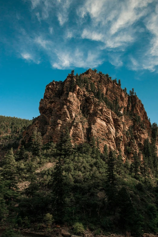 a body of water with a mountain in the background, trees and cliffs, at the top of a red rock canyon, stacked image, slide show