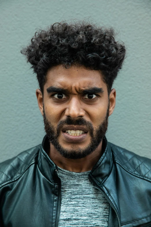a close up of a person wearing a leather jacket, trending on pexels, renaissance, very angry expression, aboriginal australian hipster, curls on top of his head, square masculine jaw