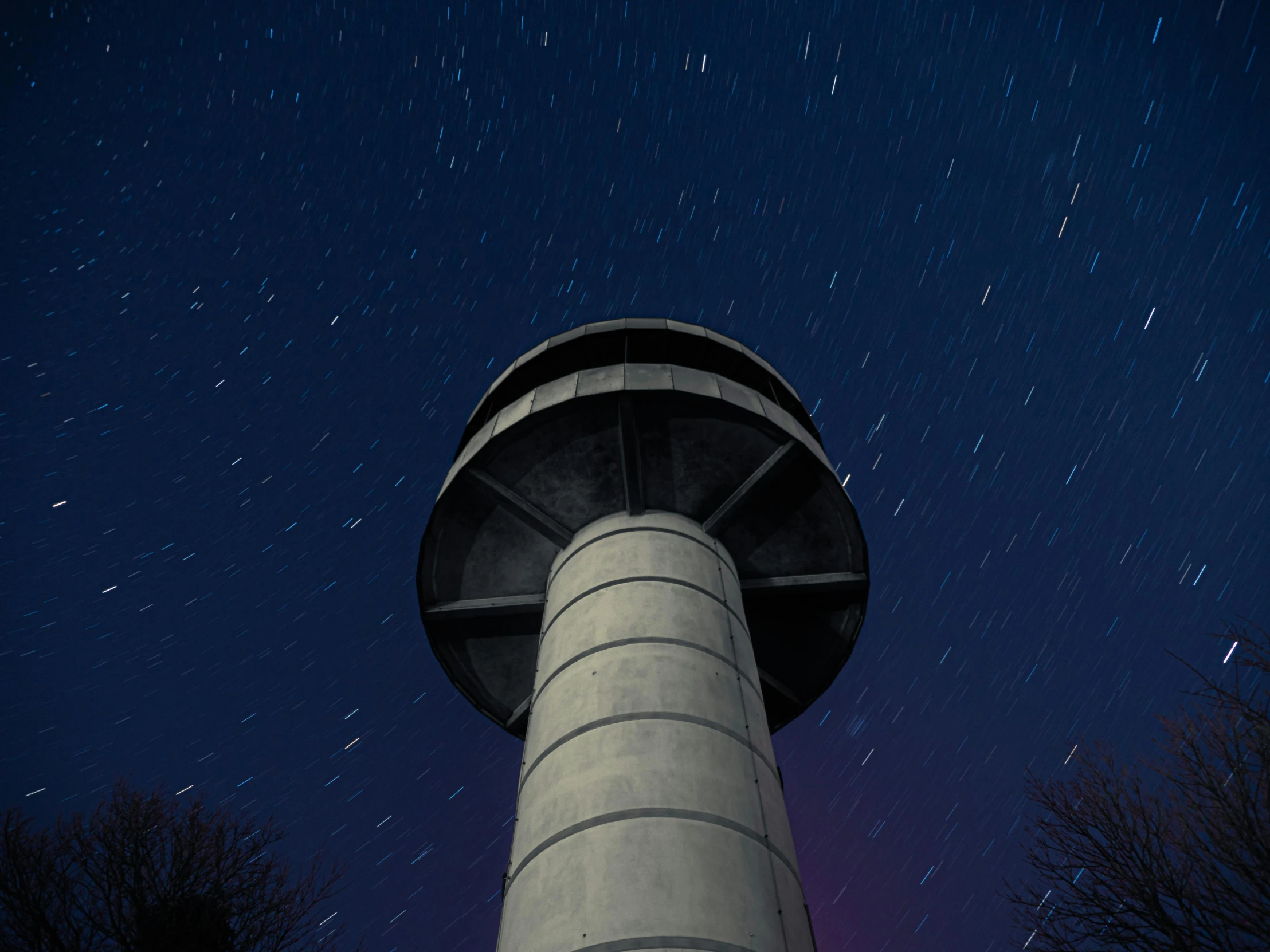 a tall tower sitting in the middle of a forest, inspired by Filip Hodas, unsplash contest winner, hurufiyya, star trails, myllypuro water tower, long exposure outside the city, thumbnail