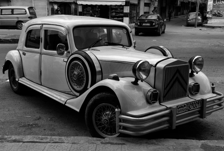 a black and white photo of an old car, a black and white photo, pexels contest winner, surrealism, in rabat henry cartier bresson, ( ( ( art deco ) ) ), finely detailed car, square