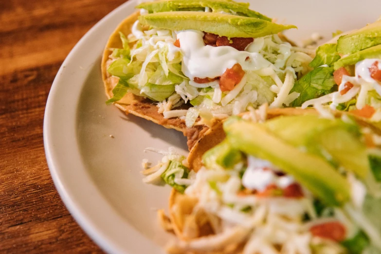 a plate topped with taco shells covered in toppings