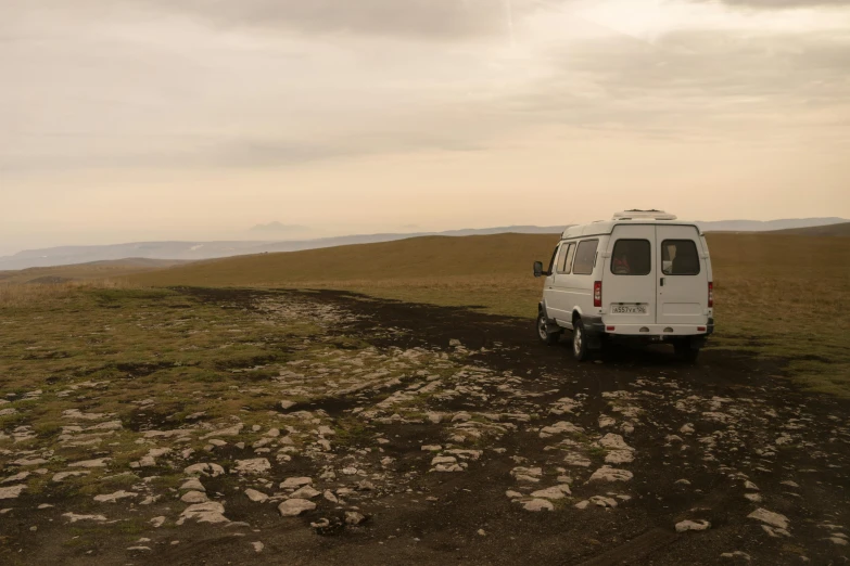 a van parked on the side of a dirt road, by Muggur, les nabis, looking onto the horizon, moss and mud, southern slav features, profile image