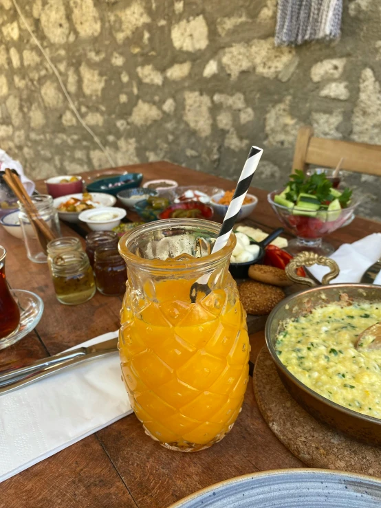 a glass filled with liquid sitting on top of a table