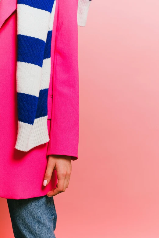 a woman in a pink coat and striped scarf, inspired by Yves Klein, trending on unsplash, de stijl, detail shot, large tall, cobalt blue, sailor clothing