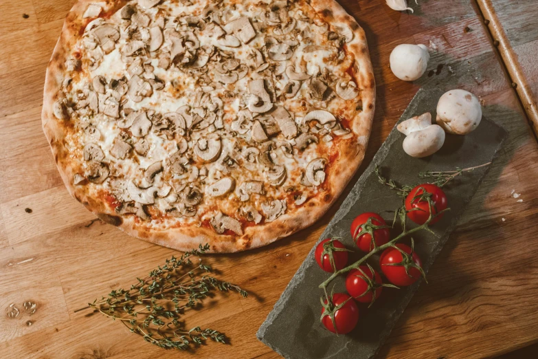 a pizza sitting on top of a wooden cutting board, moshrooms on ground, daily specials, thumbnail, mushrooms and plants