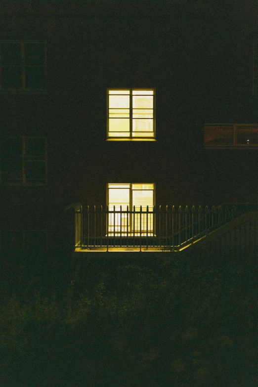 a picture of a building lit up at night, an album cover, inspired by Elsa Bleda, australian tonalism, ( ( railings ) ), yellow, ignant, michael sowa