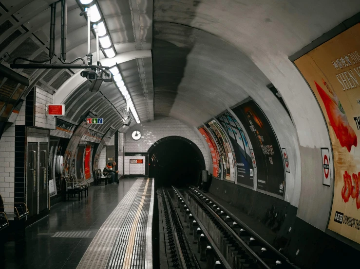 a subway station with a train coming out of the tunnel, an album cover, inspired by Thomas Struth, pexels contest winner, london, square, youtube thumbnail, haunted