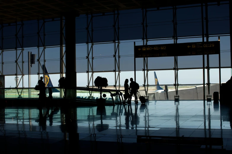 a group of people standing in an airport terminal, by Barbara Greg, pexels contest winner, blue sky, avatar image, costa blanca, silhouetted