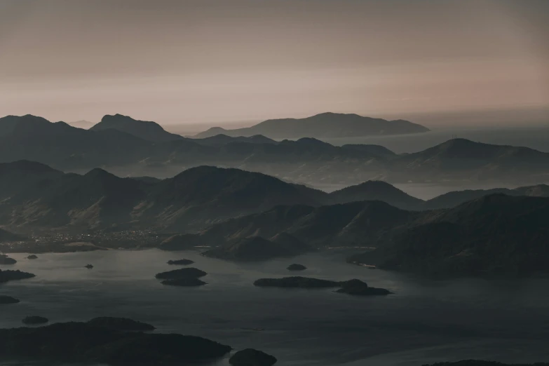 a black and white po of mountains, water and clouds