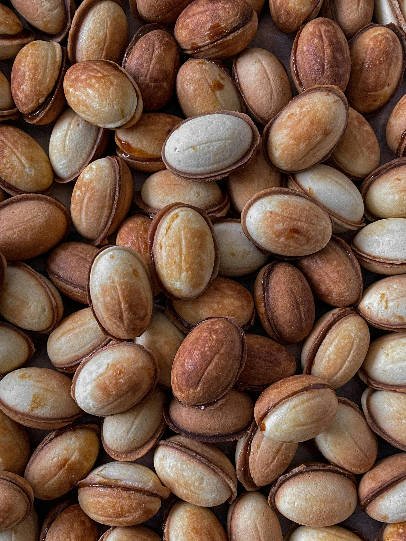 a pile of nuts sitting on top of a table, pretty oval face, thumbnail, uncropped, texas