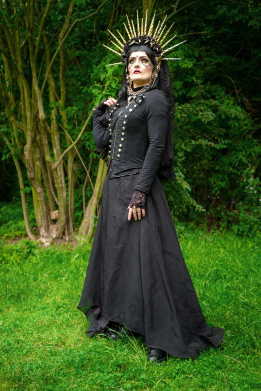 a woman in a black dress with a crown on her head, an album cover, inspired by Eleanor Fortescue-Brickdale, renaissance, outdoor photo, witchcore clothes, pose 4 of 1 6, ( steampunk )