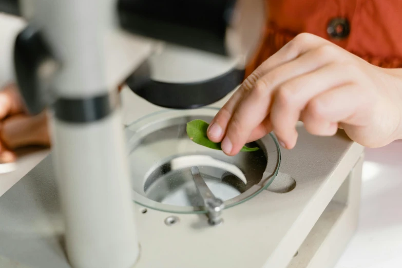 a close up of a person using a machine, a microscopic photo, trending on pexels, botanicals, plating, local conspirologist, avatar image