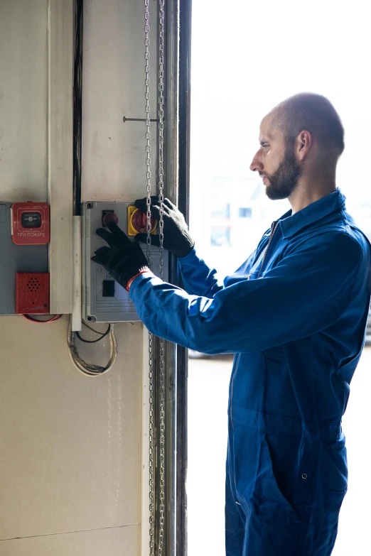 a man working on an electrical panel in a garage, by Matthias Stom, pexels, 2 5 6 x 2 5 6 pixels, on ship, seasonal, worksafe