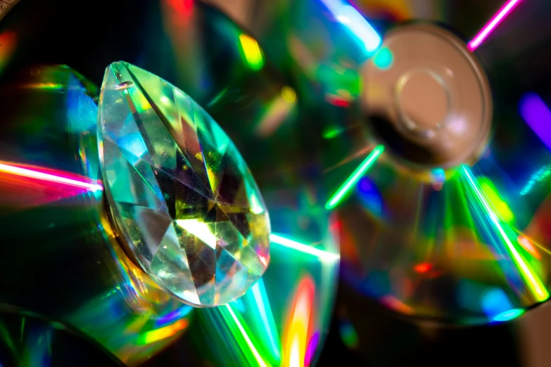 a bunch of cds sitting on top of each other, by Julia Pishtar, holography, gems and diamond for fruit, optical mineralogy, tear drop, a close up shot