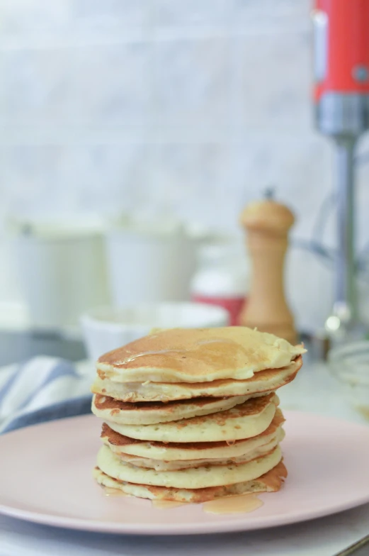 a stack of pancakes sitting on top of a pink plate, a picture, pexels, hyperrealism, background image, blond, blender, real image