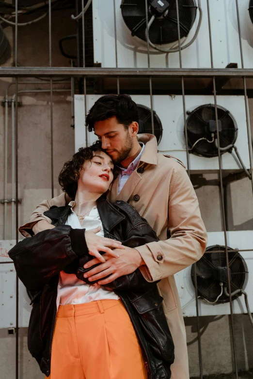 a man and a woman standing next to each other, trending on pexels, two men hugging, wearing trenchcoat, brunettes, square