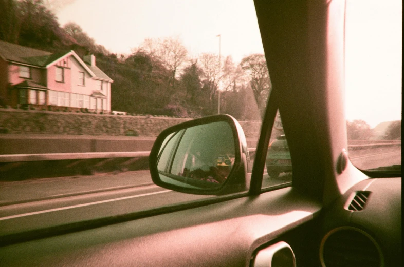 a rear view mirror of a car driving down a road, by Nathalie Rattner, holywood scene, overexposed photograph, window, :: morning