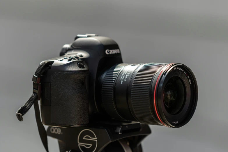 a close up of a camera on a tripod, unsplash, photorealism, taken with canon eos 5 d mark iv, sigma lens photo, (eos 5ds r, professional product photo