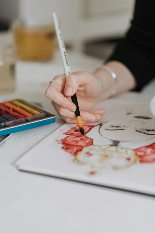 a person is doing soing with colored pencils