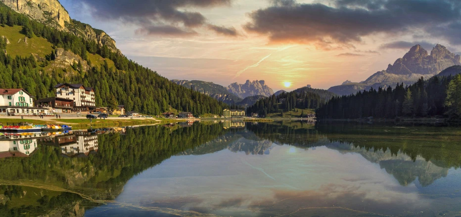 a view of mountains and houses on the shore of a body of water