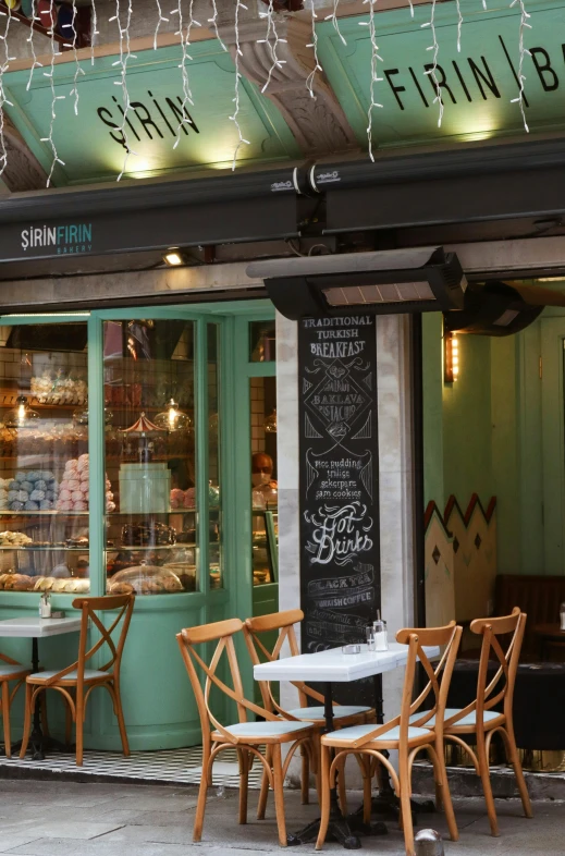 a restaurant with tables and chairs in front of it, art nouveau, cute bakery shop, seraphine, slim, london