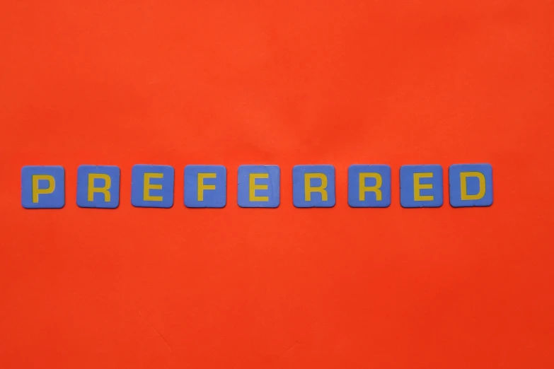 the word preferred spelled in blue letters on an orange background, inspired by Ray Crooke, shutterstock, a rubik's cube, royal commission, red shirt, interference