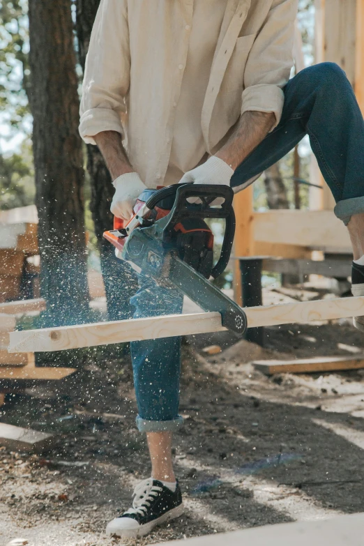 a man cutting a piece of wood with a chainsaw, pexels contest winner, full body image, blue print, commercial, petite