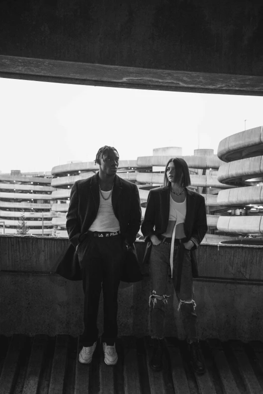 a man and a woman sitting next to each other, a black and white photo, unsplash, playboi carti, skycrapers, damaged, suns