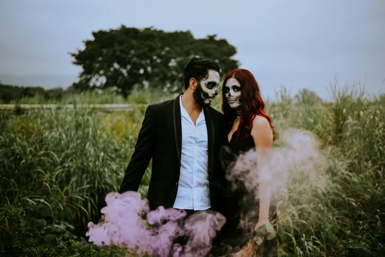 a man and woman standing next to each other in a field, pexels contest winner, international gothic, skull paint, background image, smoke grenades, instagram picture