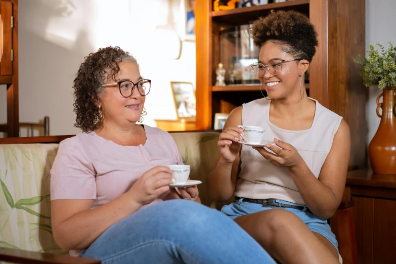 two women sitting on a couch drinking coffee, a portrait, by Lisa Milroy, trending on pexels, full figured, manuka, avatar image, 15081959 21121991 01012000 4k