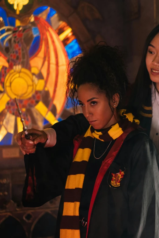 two women standing next to each other in front of a stained glass window, inspired by Hermione Hammond, casting a flame spell, ashteroth, japanese live-action movie, hogwarts