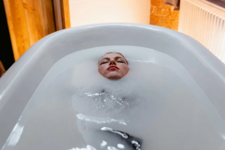 a woman laying in a bathtub filled with water, highly capsuled, ekaterina, upside down, silicone skin