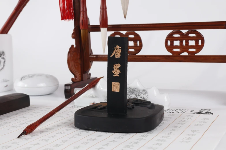 a pen sitting on top of a wooden stand, inspired by Xuande Emperor, figuration libre, kanji markings, black, detailed product image, low - angle shot