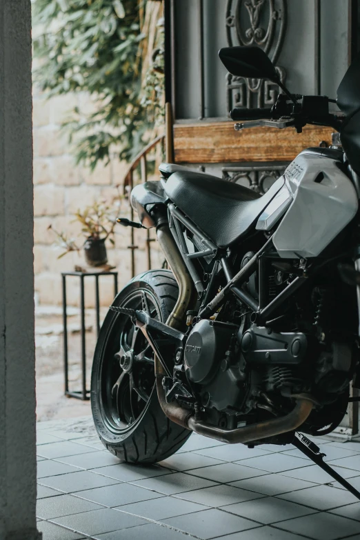 a motorcycle is parked in a garage, pexels contest winner, side view intricate details, grey, ready to model, gif