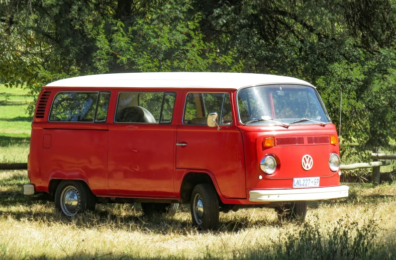 a red and white van parked in a field, arabesque, kombi, well shaded, chilean, preserved historical