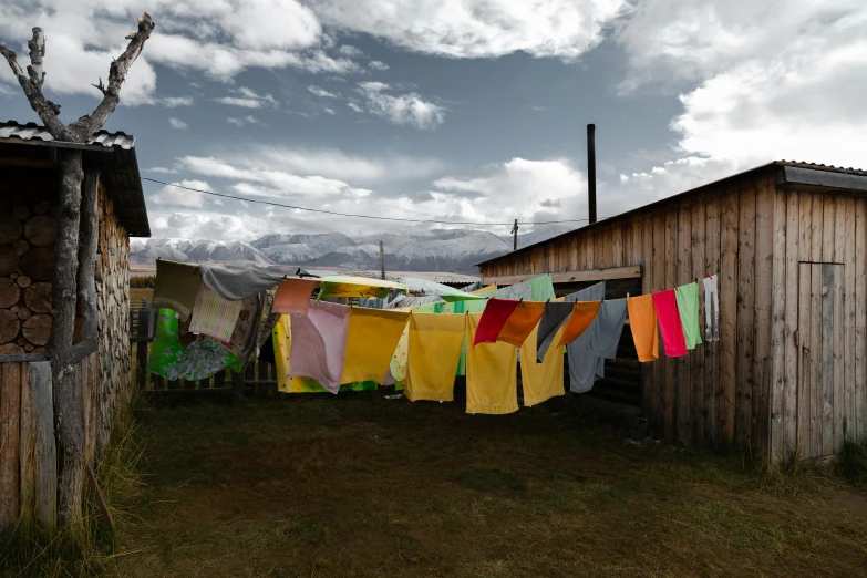 clothes hanging out to dry on a clothes line, a colorized photo, by Alison Geissler, unsplash contest winner, arte povera, neo - andean architecture, sci - fi mongolian village, slide show, ignant