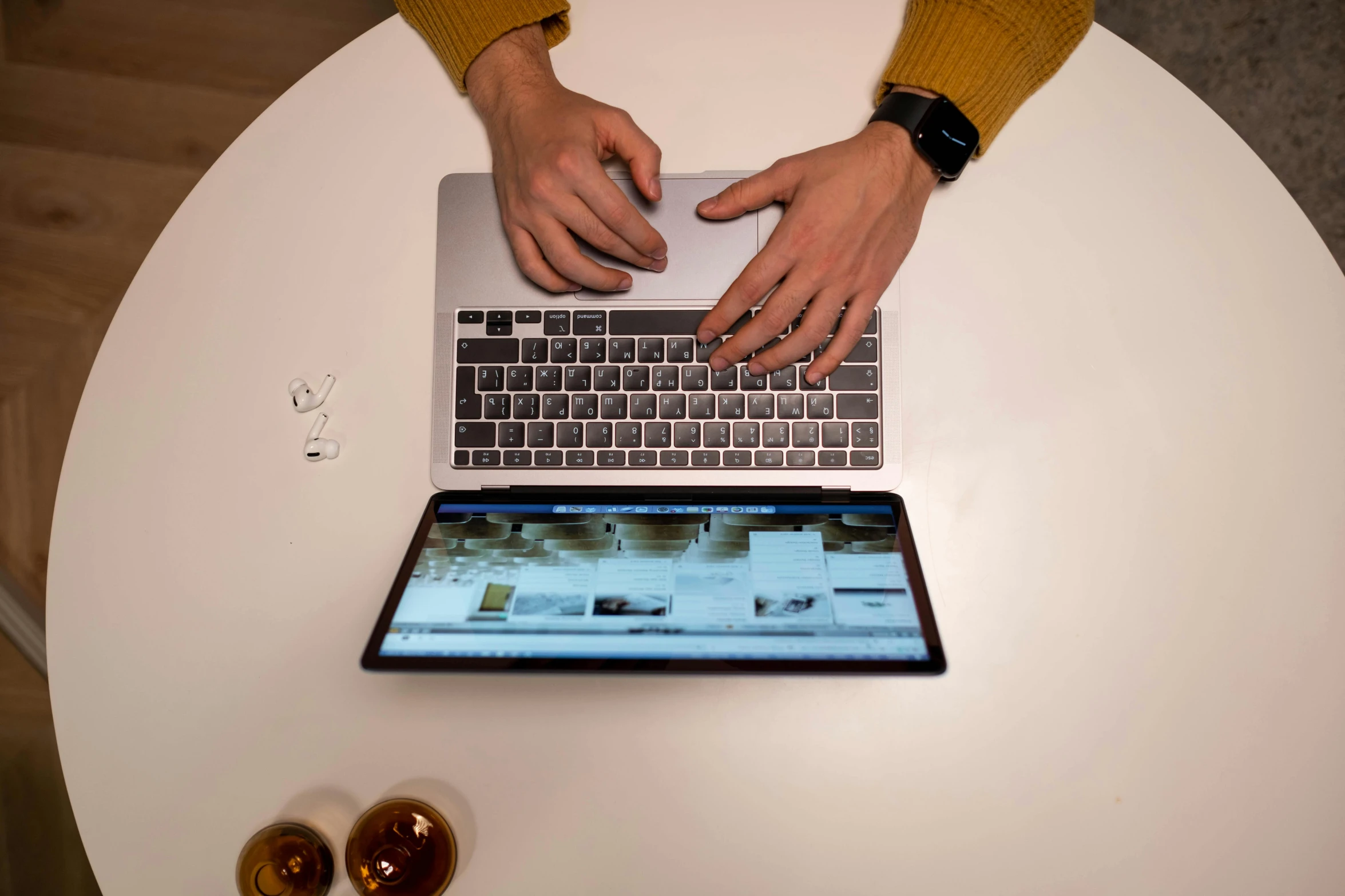 a person sitting at a table using a laptop computer, by Matthias Stom, pexels, shot on iphone 1 3 pro, “hyper realistic, item, maintenance photo