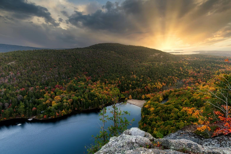 a large body of water surrounded by trees, unsplash contest winner, hudson river school, autumn sunset, looking down a cliff, boreal forest, slide show