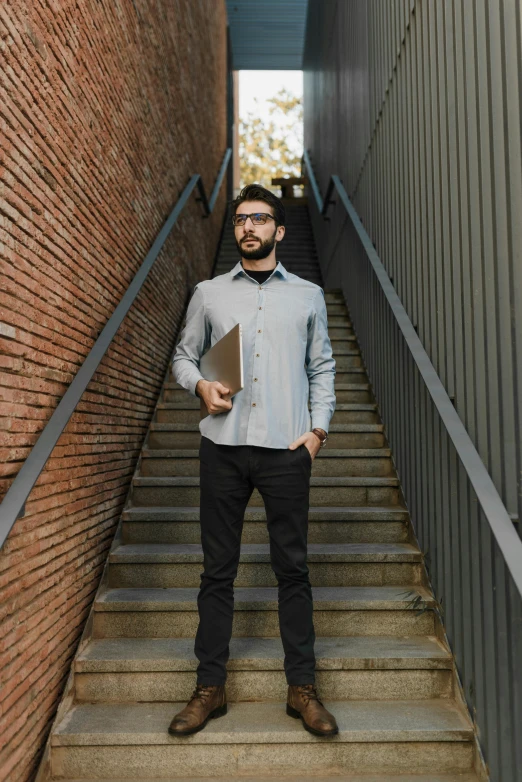 a man is standing on the stairs of an outside building