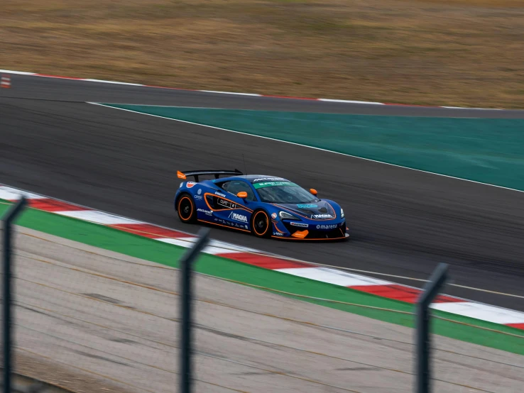 a car driving around a track on a racetrack