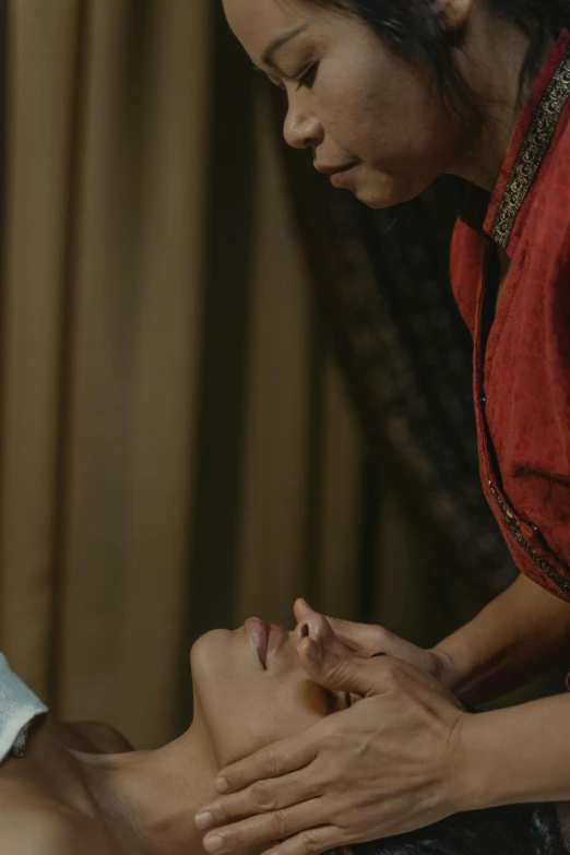 a woman getting a facial massage at a spa, by Basuki Abdullah, hurufiyya, cinematic movie still, lofi, on a dark background, scene from live action movie