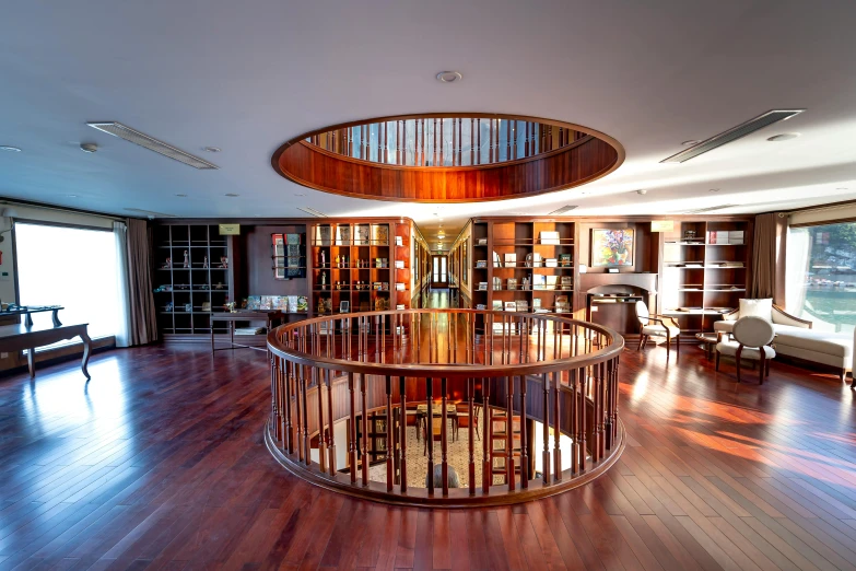 a very elegant circular wooden table and chairs