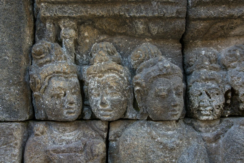 a group of stone heads sitting on top of a stone wall, pexels contest winner, sumatraism, avatar image, royal relief, thumbnail, shaved temple