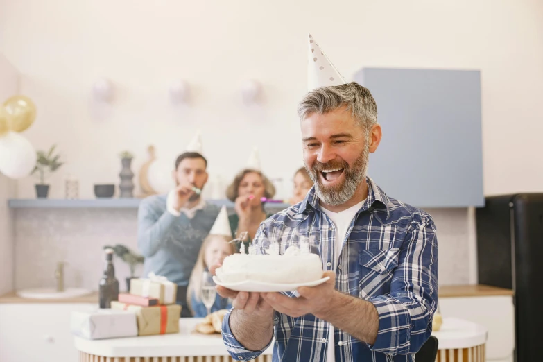 a man holding a plate with a cake on it, silver full beard, at a birthday party, promo image, grey
