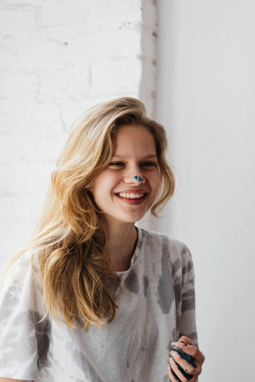 a woman sitting at a table with a plate of food, a colorized photo, inspired by Louisa Matthíasdóttir, trending on unsplash, making the best smug smile, light brown hair blue eyes, portrait of normal teenage girl, nose ring